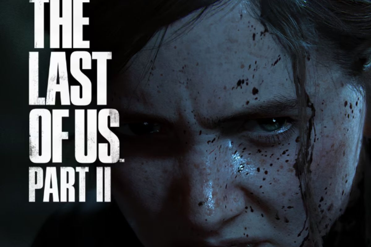 Pôster de divulgação do jogo The Last of Us 2, no qual há um close up no rosto de Ellie, que está ensanguentada e com expressão de raiva.